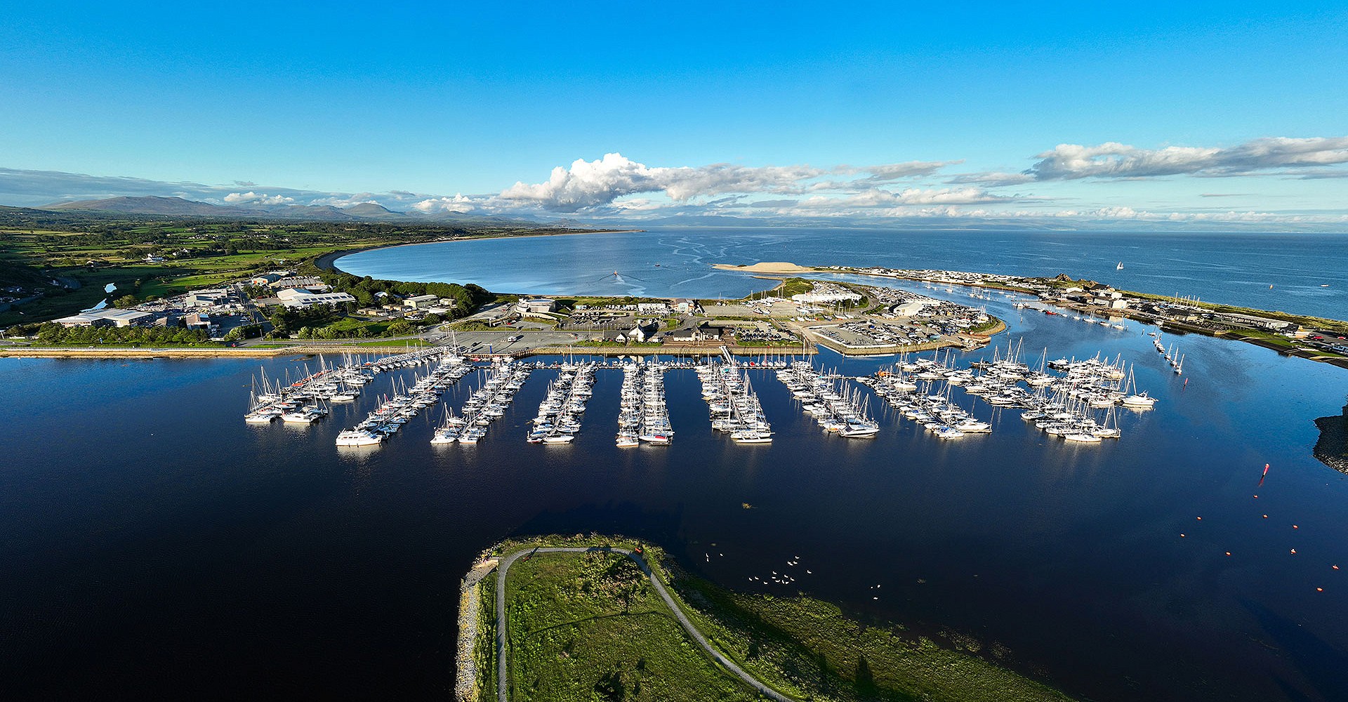 Aerial photo of parked boats in the marina and the sea in the background